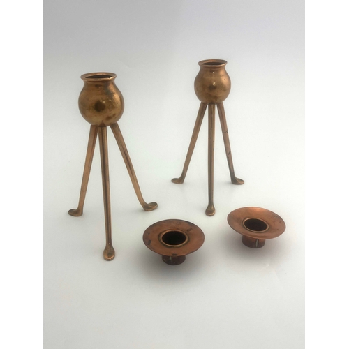 523A - Keswick School of Industrial Art, a pair of copper candlesticks, tripod bases, bud holders, sconces ... 