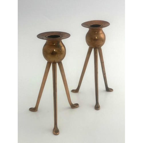 523A - Keswick School of Industrial Art, a pair of copper candlesticks, tripod bases, bud holders, sconces ... 