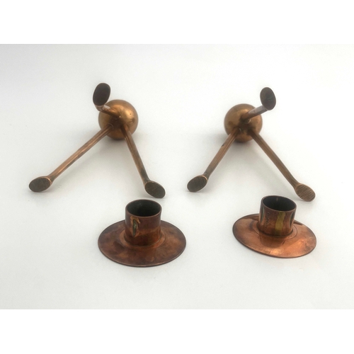 523A - Keswick School of Industrial Art, a pair of copper candlesticks, tripod bases, bud holders, sconces ... 