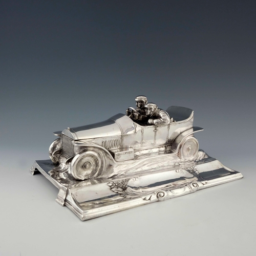 544 - WMF, a large Jugendstil silver plated desk stand, modelled as a motor car with racing drivers, scrol... 