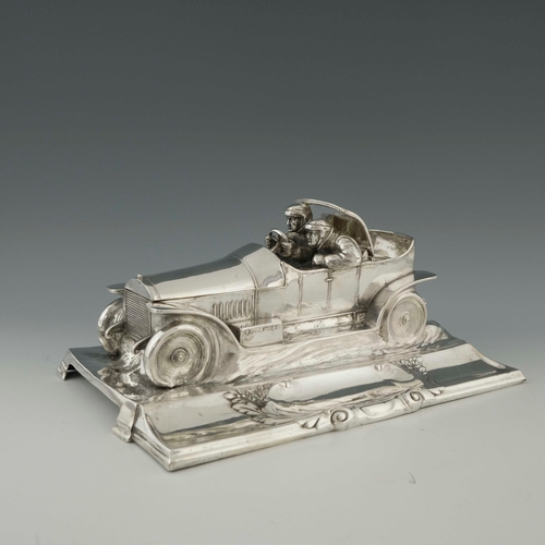 544 - WMF, a large Jugendstil silver plated desk stand, modelled as a motor car with racing drivers, scrol... 