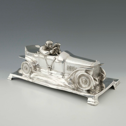 544 - WMF, a large Jugendstil silver plated desk stand, modelled as a motor car with racing drivers, scrol... 