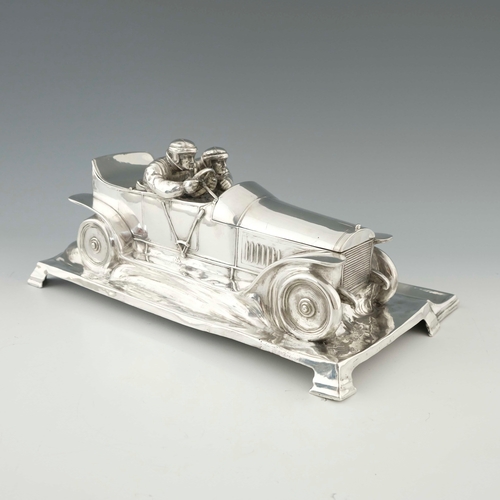 544 - WMF, a large Jugendstil silver plated desk stand, modelled as a motor car with racing drivers, scrol... 