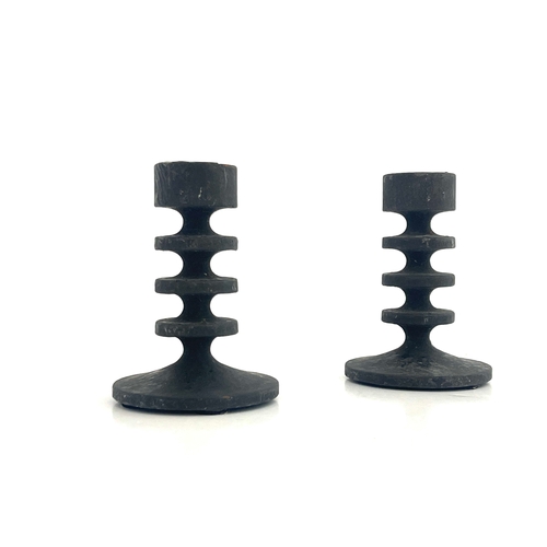 546 - Robert Welch, a pair of Campden cast iron miniature candlesticks, circa 1961, each with triple disc ... 