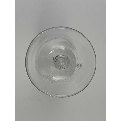 554 - An engraved opaque twist wine glass, circa 1760, the ogee bowl engraved with a basket of fruit and f... 