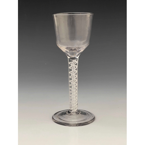 567 - An opaque twist wine glass, circa 1760, the round funnel bowl on a double series, multi stranded rib... 