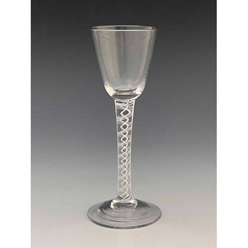 567 - An opaque twist wine glass, circa 1760, the round funnel bowl on a double series, multi stranded rib... 