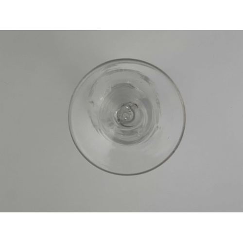 568 - An opaque twist wine glass, circa 1765, the half fluted round funnel bowl engraved with fruiting gra... 