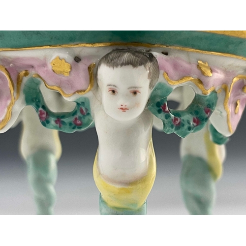 643 - A 19th century Dresden porcelain model table, the oval top painted with a Watteau type scene of a co... 