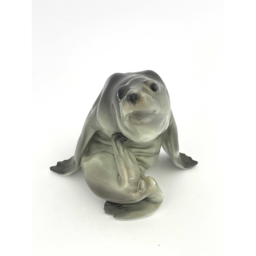 647 - KPM Berlin, a figure of a sea lion, modelled in coiled position, underglaze blue marks, 21cm high