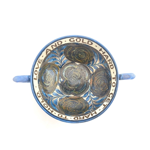 699 - John Pearson, an Arts and Crafts lustre twin handled motto bowl, the interior painted with rosettes ... 