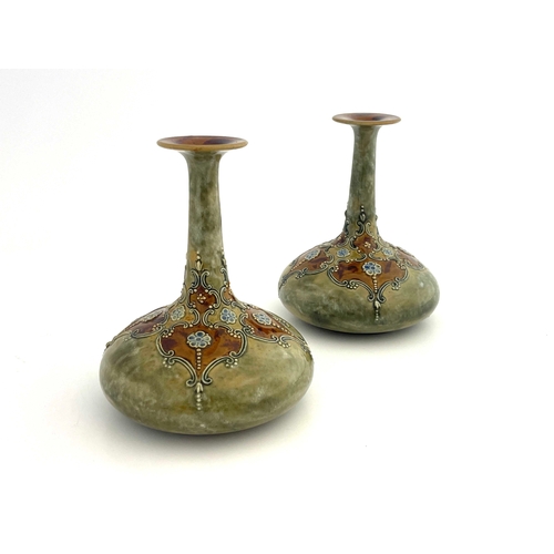 702 - A pair of Royal Doulton stoneware vases, onion bottle form, relief moulded floral and scroll decorat... 