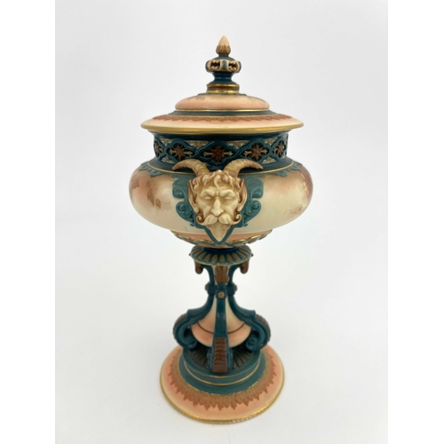 772 - A Hadleys Worcester pedestal vase and cover, modelled with twin horned mask handles, painted with mo... 