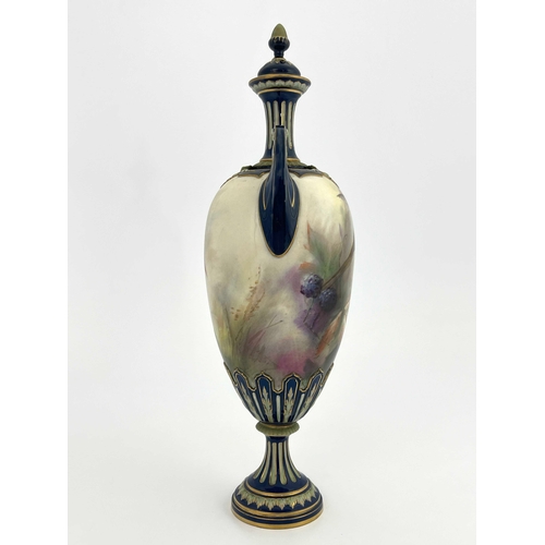 773 - A Hadleys Worcester twin handled vase and cover, relief moulded pedestal urn form, painted with a ph... 