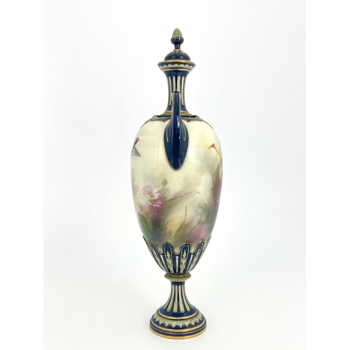 773 - A Hadleys Worcester twin handled vase and cover, relief moulded pedestal urn form, painted with a ph... 