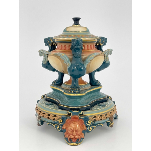 774 - A Hadleys Worcester inkwell, reticulated and relief moulded, the pedestal urn supported on three tra... 