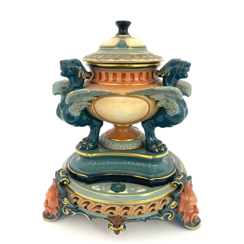 774 - A Hadleys Worcester inkwell, reticulated and relief moulded, the pedestal urn supported on three tra... 