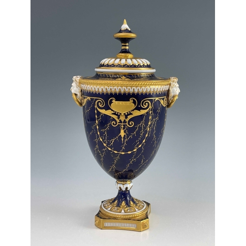 789 - Harry Davies for Royal Worcester, a landscape painted urn vase, twin handled pedestal form, the demi... 