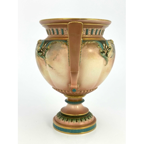 804 - A Hadleys Worcester pedestal vase, twin handled, painted with roses below relief moulded foliate bor... 