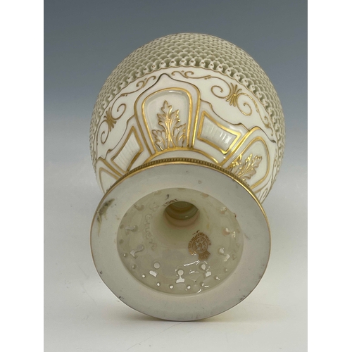 808 - George Owen for Royal Worcester, a reticulated ewer, 1919, pedestal ovoid form, pierced with hexagon... 