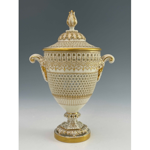 809 - George Owen for Royal Worcester, a reticulated twin handled pedestal vase and cover, 1919, urn form,... 