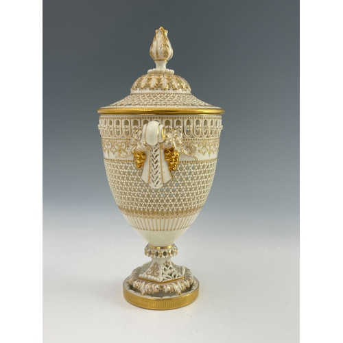 809 - George Owen for Royal Worcester, a reticulated twin handled pedestal vase and cover, 1919, urn form,... 