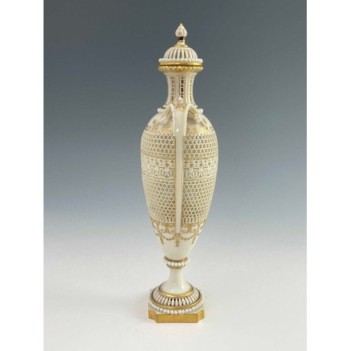 810 - George Owen for Royal Worcester, a reticulated twin handled pedestal vase and cover, 1911, elongated... 