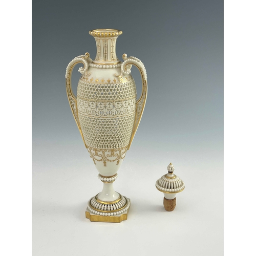 810 - George Owen for Royal Worcester, a reticulated twin handled pedestal vase and cover, 1911, elongated... 