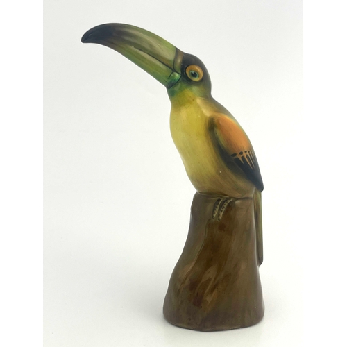 812 - A Royal Doulton figure of a toucan, HN159, modelled on a stump, 19cm high