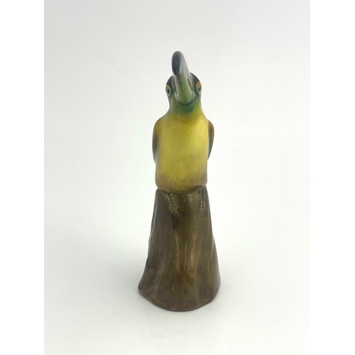 812 - A Royal Doulton figure of a toucan, HN159, modelled on a stump, 19cm high