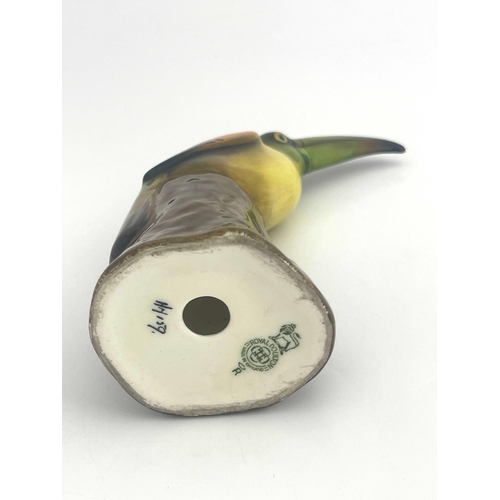 812 - A Royal Doulton figure of a toucan, HN159, modelled on a stump, 19cm high