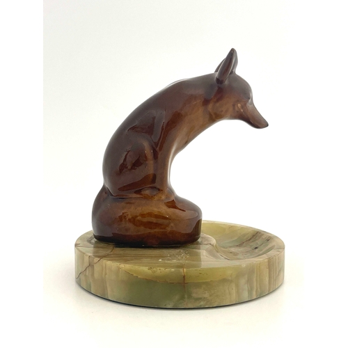 813 - A Royal Doulton Kingsware figure ashtray, modelled as a fox, mounted on an onyx troughed dish, 17cm ... 