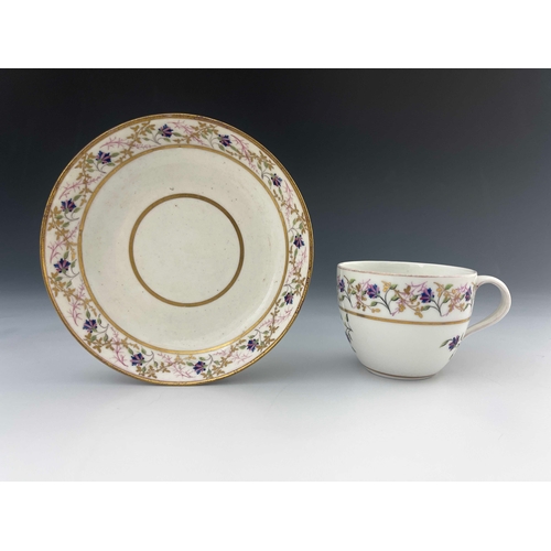 823 - A Pinxton porcelain tea cup and saucer, pattern 14, circa 1800, painted and gilded with chantilly sp... 