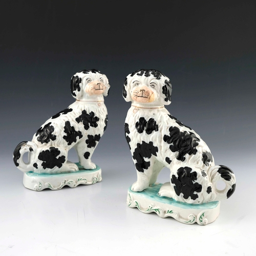 830 - A pair of Staffordshire pottery chimney spaniels, circa 1870, white with black spots and 'Disraeli' ... 