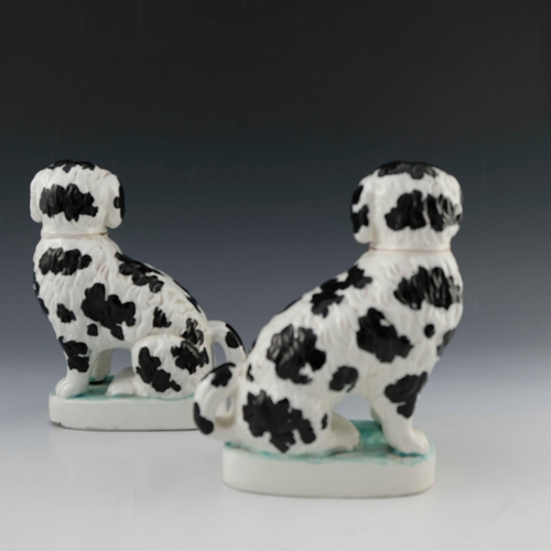 830 - A pair of Staffordshire pottery chimney spaniels, circa 1870, white with black spots and 'Disraeli' ... 