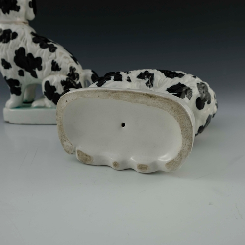 830 - A pair of Staffordshire pottery chimney spaniels, circa 1870, white with black spots and 'Disraeli' ... 