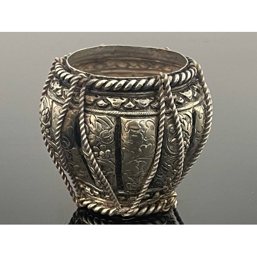 1 - An Indian white metal pot, circa 1910, repousse embossed and chased lobed form with foliate scroll p... 