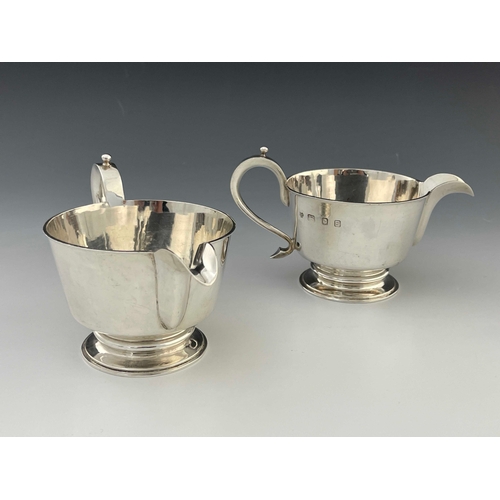 18 - A pair of Elizabeth II silver jugs, in the Charles II style, footed conical form, ear handles, 18.5m... 