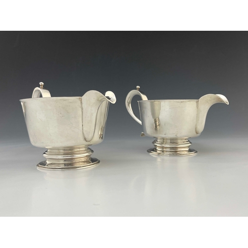 18 - A pair of Elizabeth II silver jugs, in the Charles II style, footed conical form, ear handles, 18.5m... 