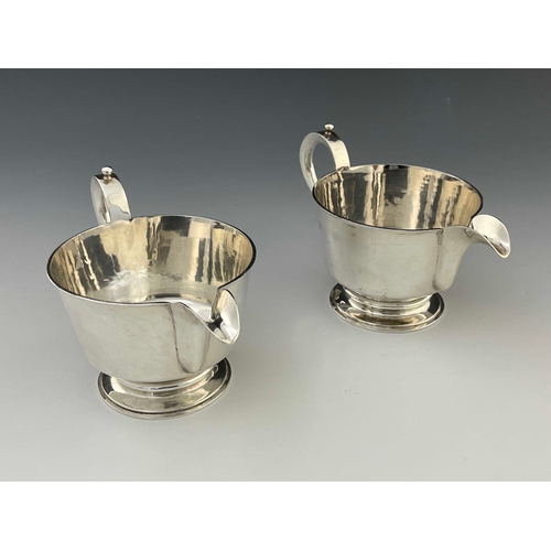 18 - A pair of Elizabeth II silver jugs, in the Charles II style, footed conical form, ear handles, 18.5m... 