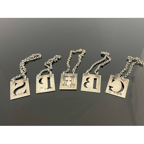 20 - Five George III silver wine labels, four cut-out letters, 'P', 'S', 'G',  'B' unmarked, and 'Rye' ov... 