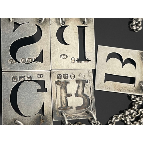 20 - Five George III silver wine labels, four cut-out letters, 'P', 'S', 'G',  'B' unmarked, and 'Rye' ov... 