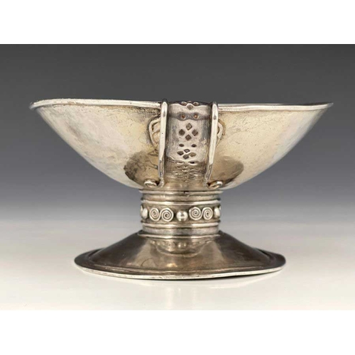 67 - An Arts and Crafts single handled cup, in the Revivalist style of an ancient drinking vessel, the sh... 