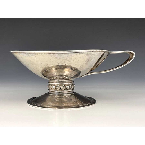 67 - An Arts and Crafts single handled cup, in the Revivalist style of an ancient drinking vessel, the sh... 