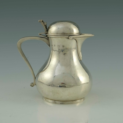 68 - Duchess of Sutherland's Cripples' Guild, an Arts and Crafts silver lidded jug, Birmingham 1911, plan... 