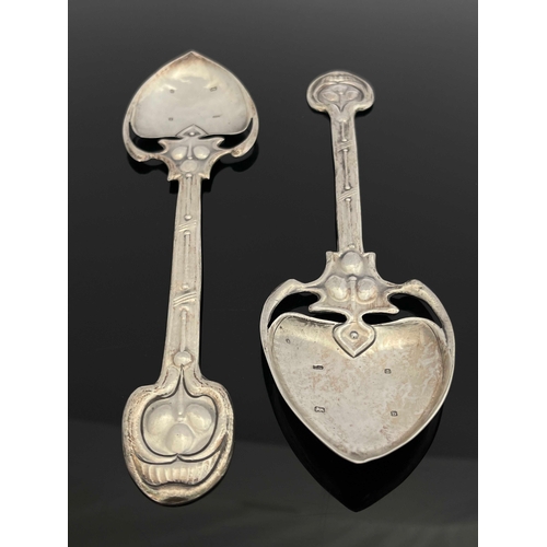 71 - A pair of Arts and Crafts silver spoons, TW, Birmingham 1901, the planished spade bowls on open tend... 