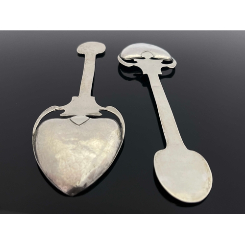 71 - A pair of Arts and Crafts silver spoons, TW, Birmingham 1901, the planished spade bowls on open tend... 