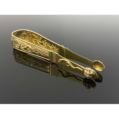 9 - A large pair of Continental silver gilt sugar tongs, circa 1790, cast and chased in relief with foli... 