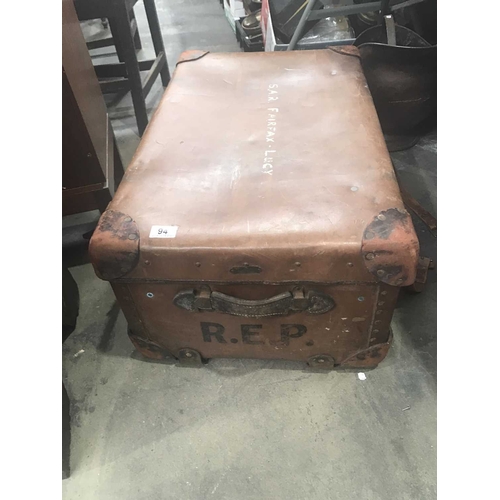 94 - A large vintage leather trunk, with leather corner guards, stamped R.E.P.