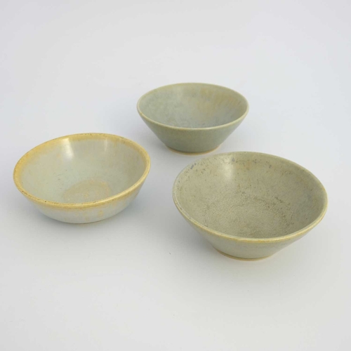 137D - Ruskin Pottery, three crystalline bowls, 1927, conical and rounded forms, green grey glazed, impress... 